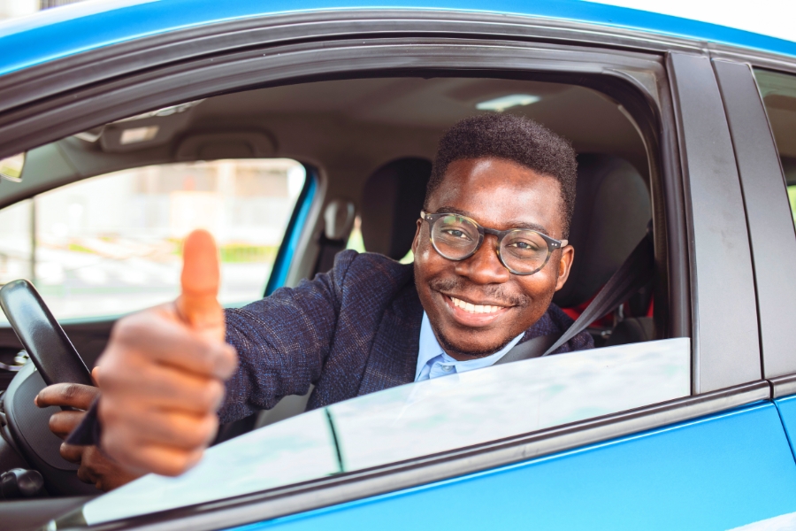 Man Driving a Blue Car