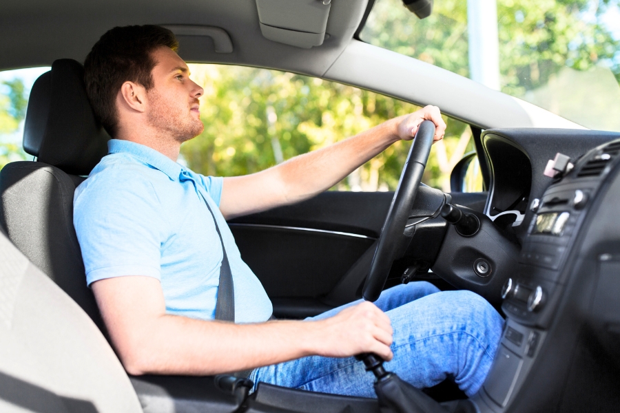 Man Driving a Silver Car