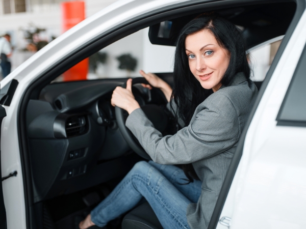 Woman Driving a White Car