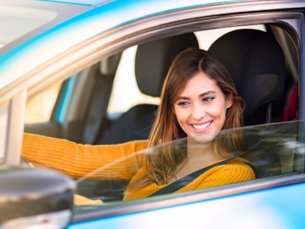 Woman Driving a Blue Car