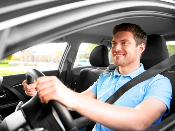 Man Driving a Silver Car