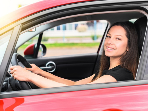 Woman Driving a Red Car